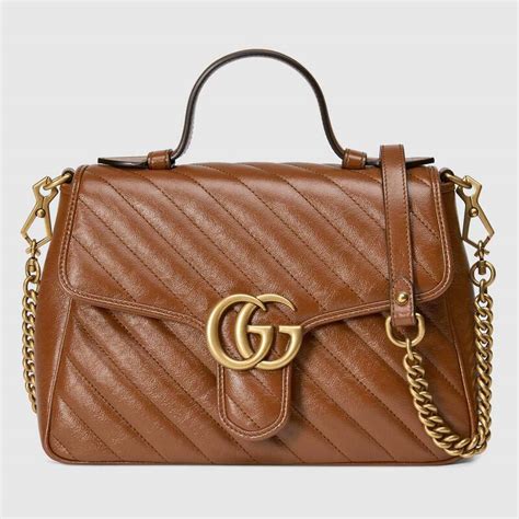 Gucci กระเป๋า GG Emblem small top handle bag.